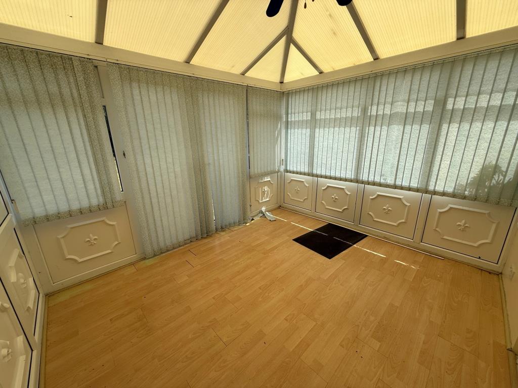 Lot: 111 - END-TERRACE ONE-BEDROOM HOUSE - Conservatory with French doors leading to communal garden